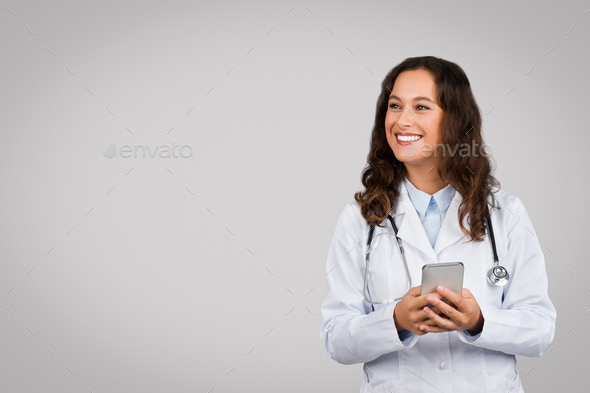 Friendly woman doctor with phone ready for telehealth