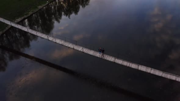 Tourists Walk about Suspension Bridge alt
