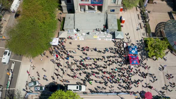 Sinking View of an Anti-Mask Protest Rally, wide daytime aerial in UHD alt