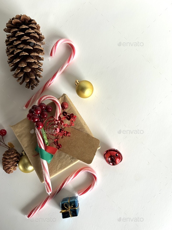Candy canes pinecones and gift on white background Stock Photo by melpaul199