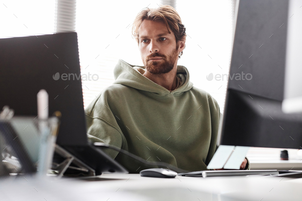 IT Developer Working on IT Project Using Multiple Computer Devices
