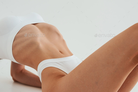 Woman in white underwear with slim body type against white background Stock  Photo by mstandret