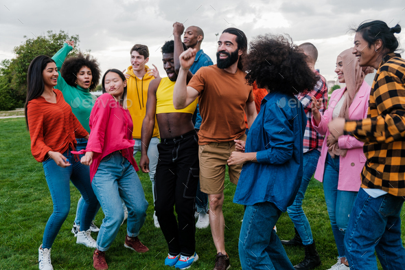 Group of young people of multi-ethnic origin dancing together outdoors