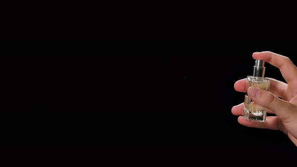 A Man Sprays a Hygienic Alcohol Spray for Disinfection and Prevention of COVID 19. Splashes on a alt