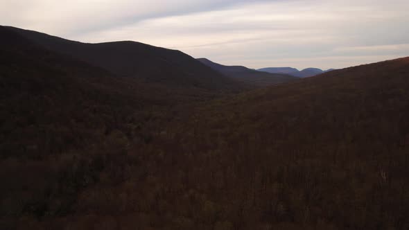 Aerial drone footage of a red and gold colored sunset golden hour in the Appalachian mountains durin alt