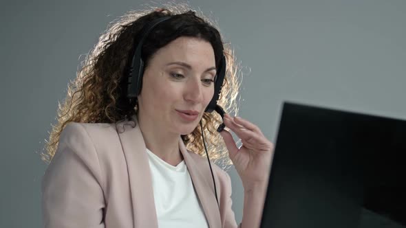 Customer Support Agent or Call Center with Headset Works on Desktop Computer While Supporting the alt