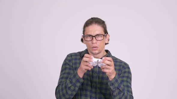 Handsome Hipster Man Looking Focused While Playing Games alt