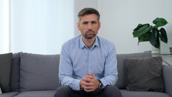 Portrait Sad Man Patient Sitting on Couch in Clinic Office Looking Camera alt