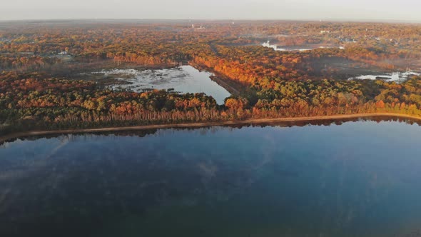 Lake Embedded in a Big Forest in Early Autumn Misty Morning alt