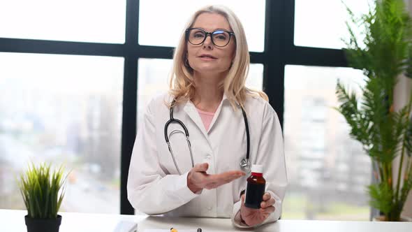 Confident Therapist Holds a Bottle of Remedy alt