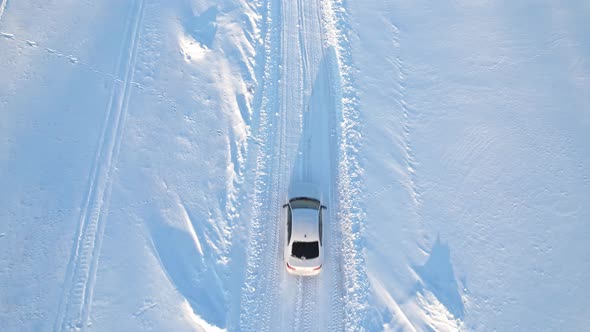 A White Car On A Winter Road