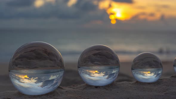 It's Like There Are Four Worlds Arranged By Size In The Sand. alt