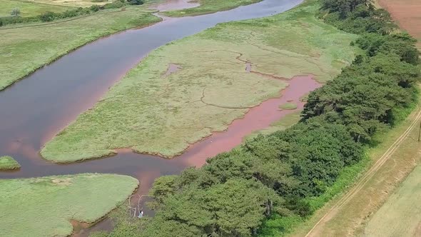 Aerial pan, River Otter and agricultural pastures by a coastal town in Devon, England, STATIC CROP Z alt