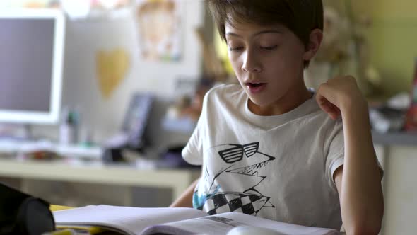Boy writing on book