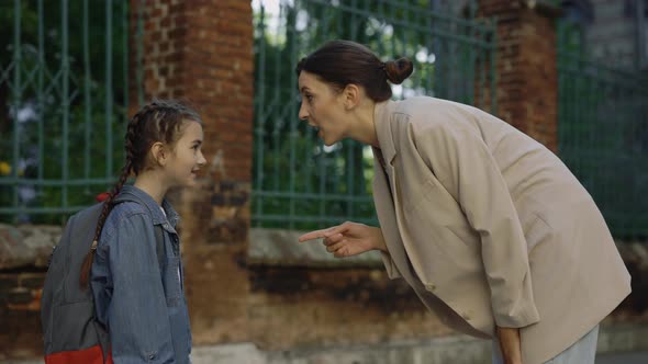 Mothes Stands and Talks with Child Gives Recommendations on the Street Before Lessons alt