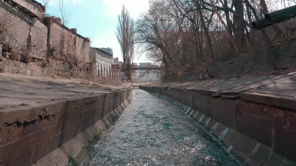 The River Flowing in a Concrete Reservoir in the City