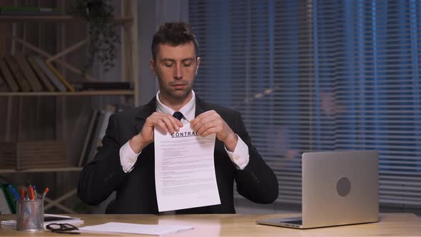 Businessman Holds Contract in Her Hands and Ripping It Apart alt