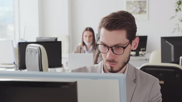 Businesspeople Working in Office during Pandemic alt
