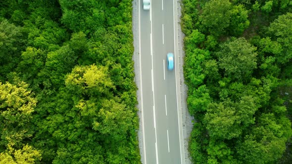 Aerial top drone view of high-speed road between the picturesque mountains.