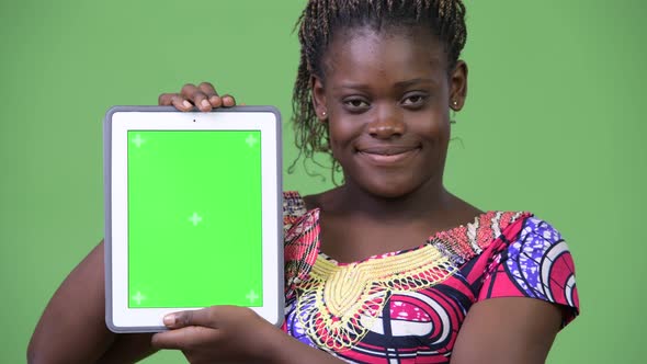 Young African Woman Showing Digital Tablet alt