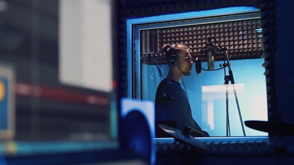 Male Rap Singer with Headphones and Sound Engineer Are Recording a New Song alt