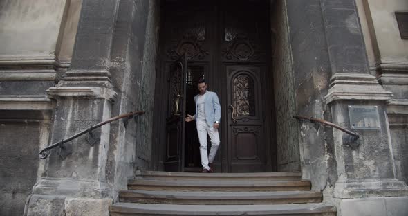 The Guy Comes Out Of The Ancient Palace. On A Tour Of The Potocki Castle alt