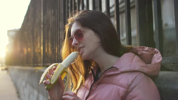 Woman eating a banana in the city