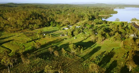 Aerial view over a campsite at a lake. alt