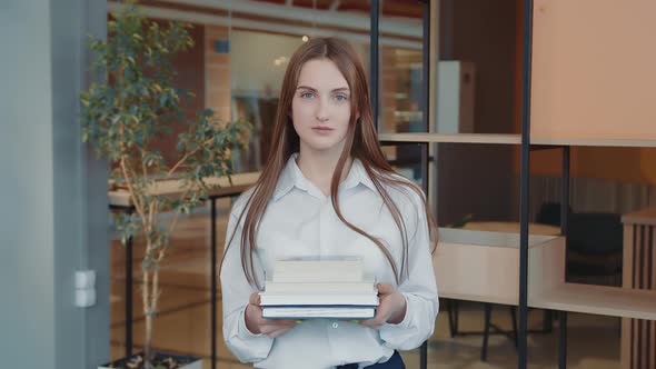 Portrait of a Schoolboy of the Senior Classes with Books in Hands in a School Class alt