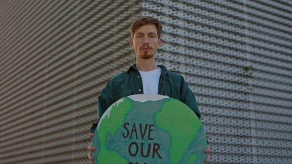 Caucasian Bearded Guy Holding Banner with Save Our Planet alt