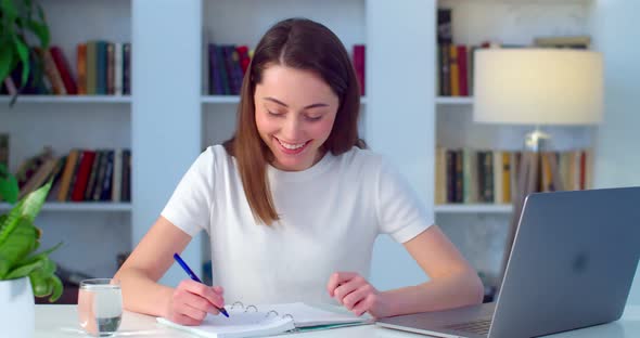 Young Woman Studying Online Chatting To Web Camera Video Call on Coronavirus Lockdown alt