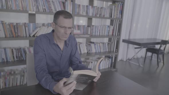 Businessman Reading Book In A Hotel Lobby