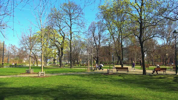 A Beautiful Green Park on a Sunny Day with People alt