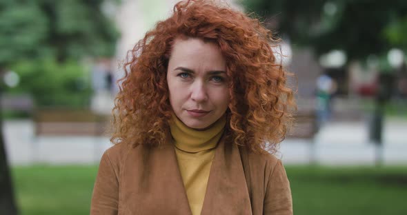 Close Up View of Extremely Beautiful Ginger Curly Girl Looking at the Camera Smiling. Modern alt
