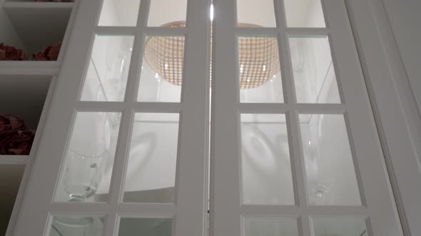 White Kitchen Cabinets with Glass Doors Illuminated From the Inside Crockery Shelves alt