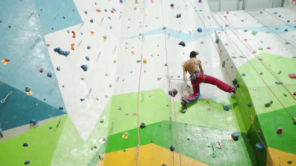 Sportsman climber moving up on steep rock