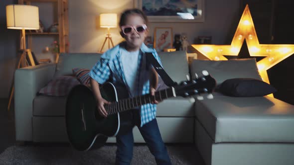 Little Girl Child Home In Room Playing Guitar And Having Fun alt