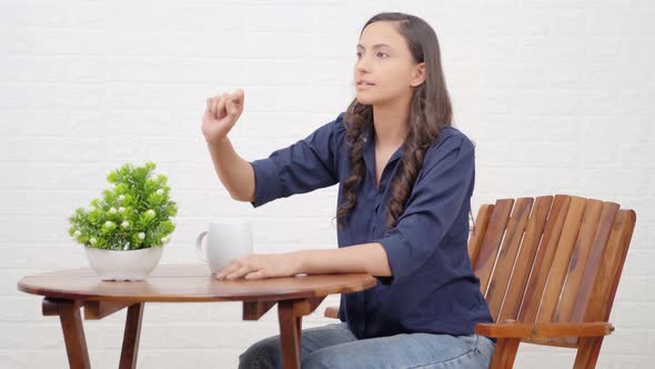 Indian girl calling a waiter alt