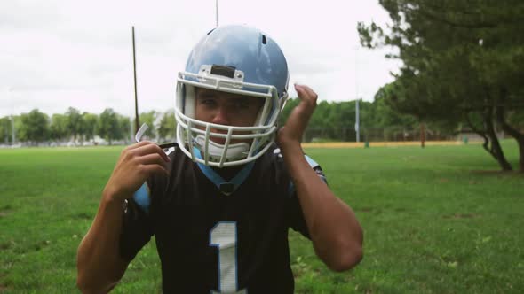 Football Player Putting On His Helmet 03