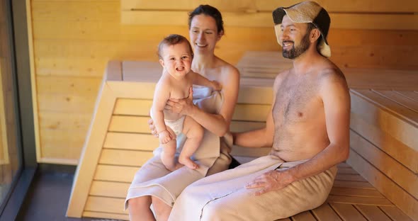 Young Family with a Little Boy in Sauna alt