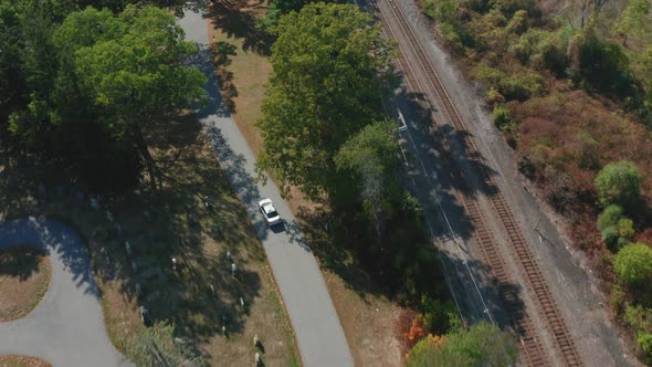 Aerial Drone Shot Tracking a Car Driving Through Mt Feake Cemetery in Waltham MA alt