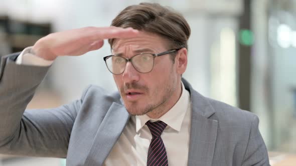 Portrait of Curious Businessman Looking Around, Searching  alt