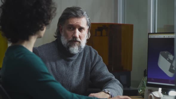 Male Colleagues Discussing 3D Detail on Computer alt