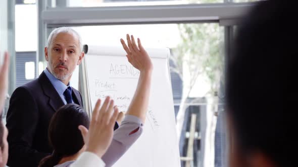 Businessman giving a presentation in a meeting alt