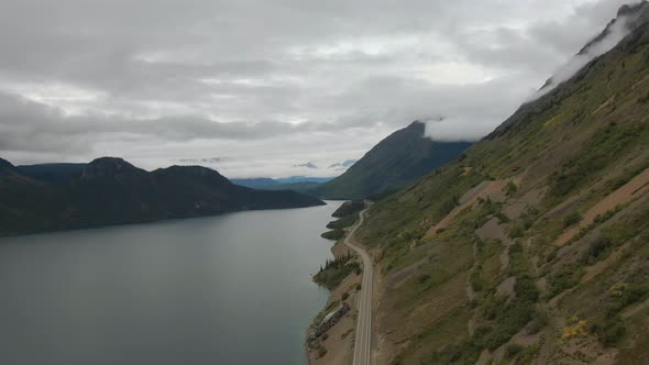 Beautiful View of Scenic Road Alongside Peaceful Lake alt