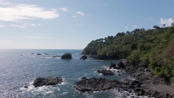 birds eye view of playitas shore where the pacific ocean meets the rocky coastline of costa rica alt