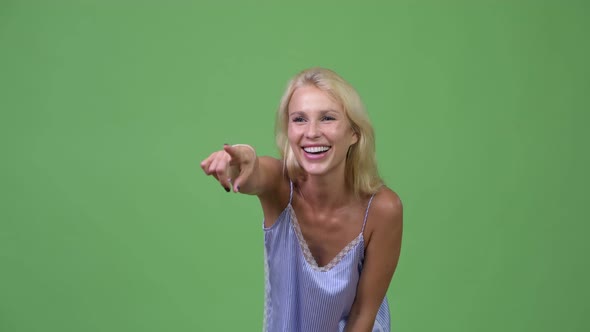 Young Happy Beautiful Businesswoman Laughing While Pointing Finger
