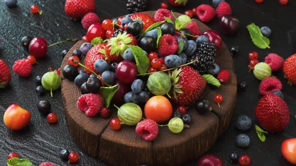 Collection of wild berries on black background, top view, 4K UHD video footage alt