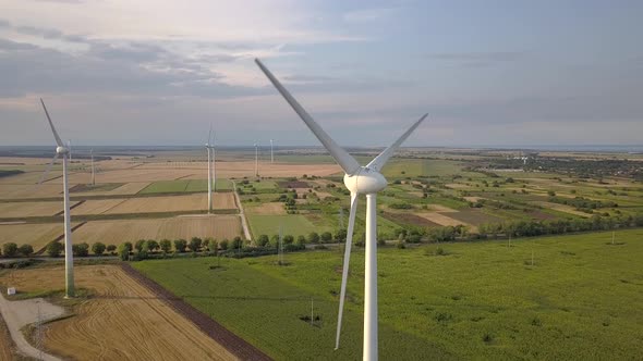 Aerial view of wind turbine generators in field producing clean ecological electricity. alt