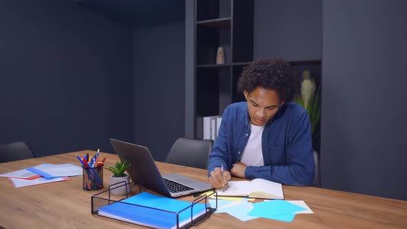 Young Employee in Startup Company Writes To Do List alt